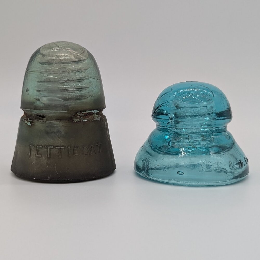 Antique Two Glass Insulators AT & T Co. and H.G. Co. Petticoat Cracks Damaged